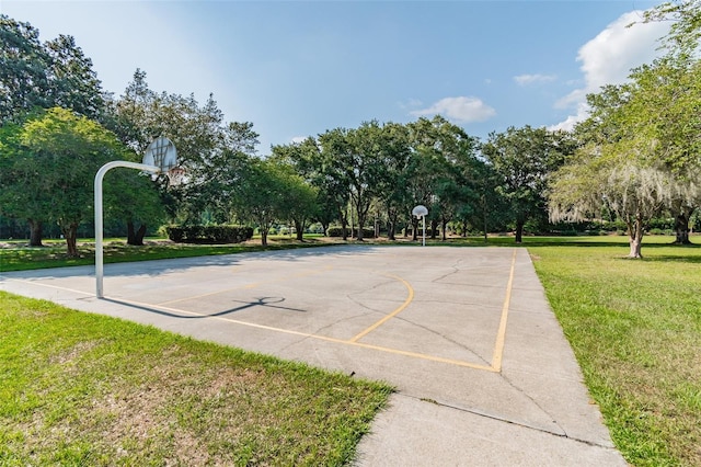 view of sport court featuring a yard