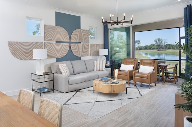 living room with light wood-type flooring, a water view, and a notable chandelier