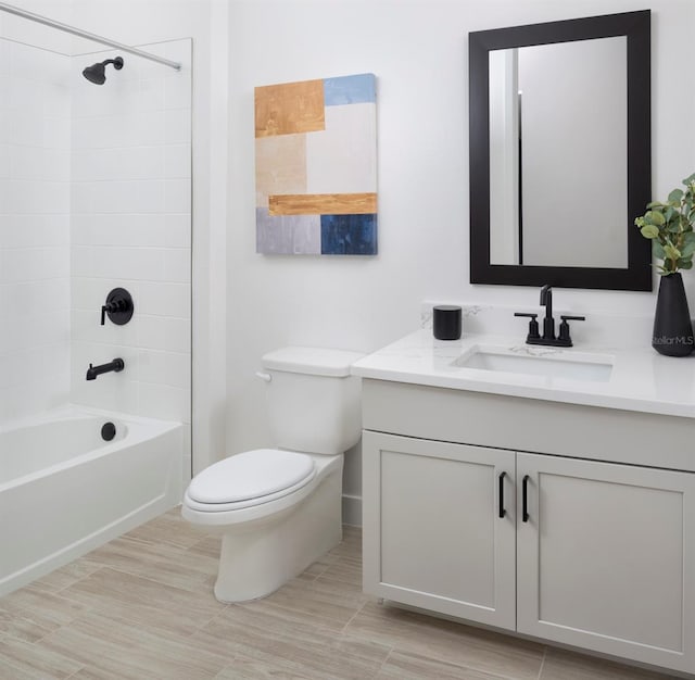 full bathroom with vanity, tiled shower / bath, and toilet