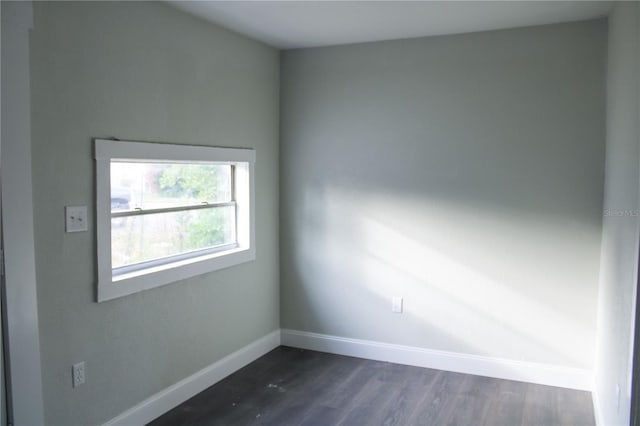 unfurnished room with dark wood-type flooring