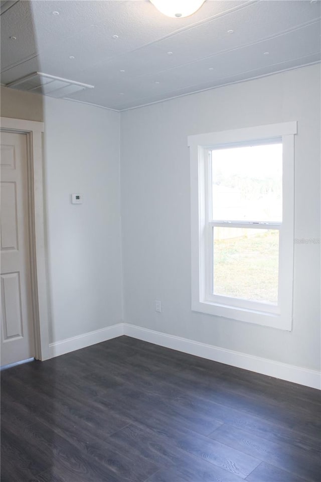 unfurnished room featuring dark hardwood / wood-style flooring