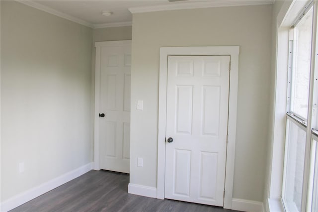 unfurnished bedroom featuring multiple windows, dark hardwood / wood-style floors, and crown molding