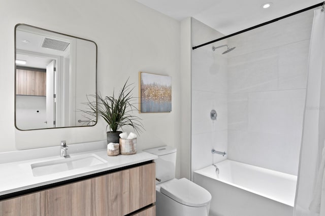 full bathroom featuring vanity, toilet, and tiled shower / bath