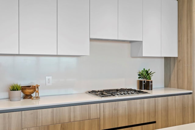 kitchen featuring white cabinets and stainless steel gas cooktop