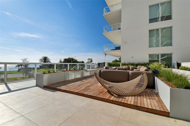 view of home's community featuring outdoor lounge area and a water view