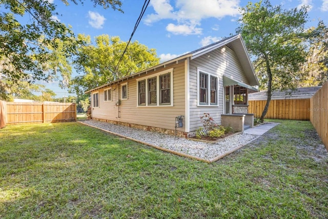 rear view of property with a lawn