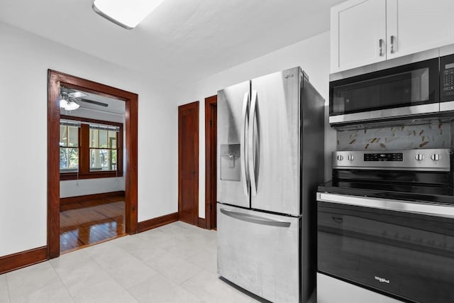 kitchen featuring light hardwood / wood-style flooring, ceiling fan, backsplash, white cabinetry, and appliances with stainless steel finishes