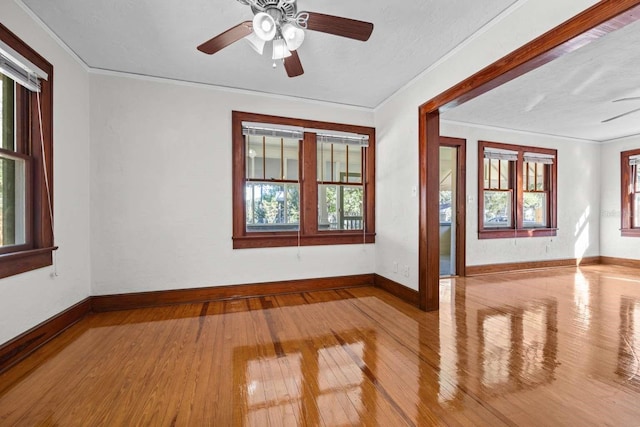 spare room featuring light hardwood / wood-style floors, ceiling fan, a textured ceiling, and crown molding