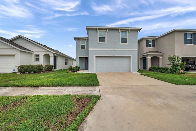 view of property featuring a front yard and a garage