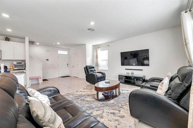 living room featuring light tile patterned floors and a textured ceiling