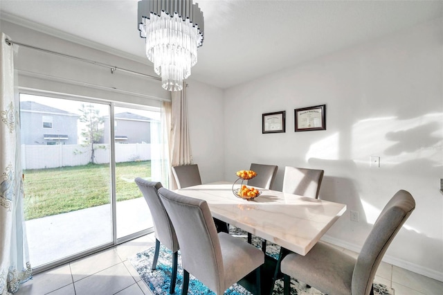 tiled dining space featuring a notable chandelier