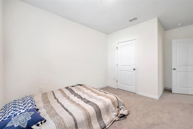 bedroom with light carpet