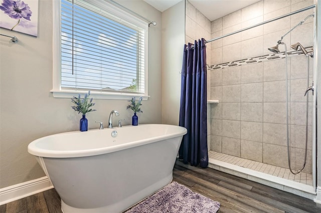 bathroom with hardwood / wood-style floors and shower with separate bathtub