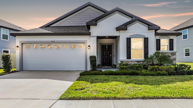 view of front of home featuring a lawn and a garage