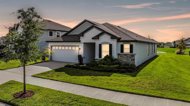 view of front of home featuring a lawn and a garage