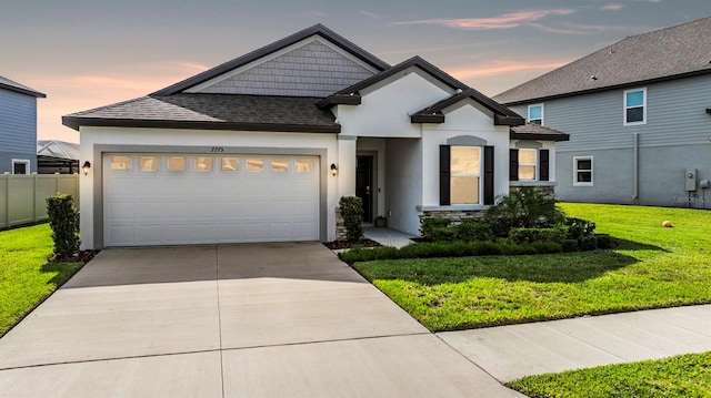 view of front of property with a yard and a garage