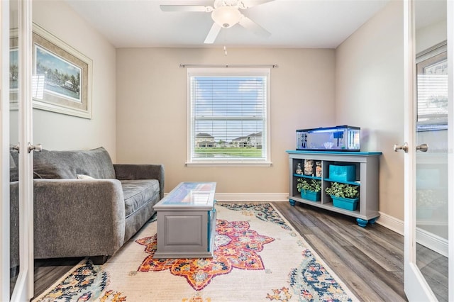 sitting room with ceiling fan, wood-type flooring, a wealth of natural light, and french doors