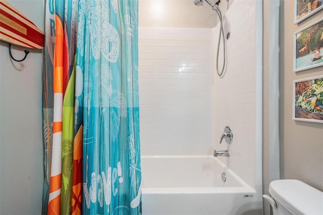 bathroom featuring toilet and shower / bath combo with shower curtain