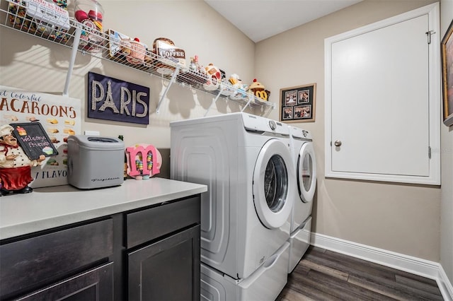 laundry area featuring separate washer and dryer, cabinets, and dark hardwood / wood-style floors