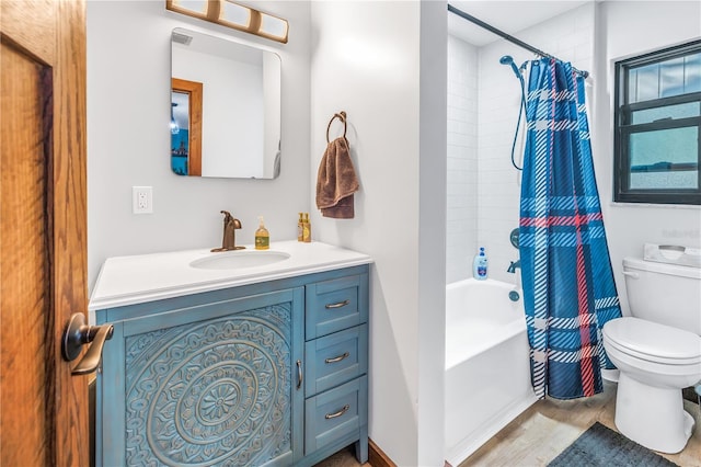 full bathroom with hardwood / wood-style floors, vanity, toilet, and shower / tub combo