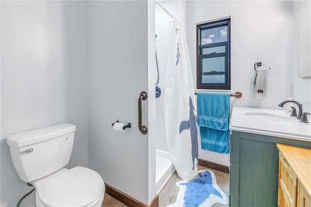 bathroom featuring toilet, vanity, wood-type flooring, and walk in shower