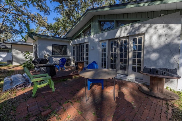 view of patio / terrace featuring a wooden deck and french doors