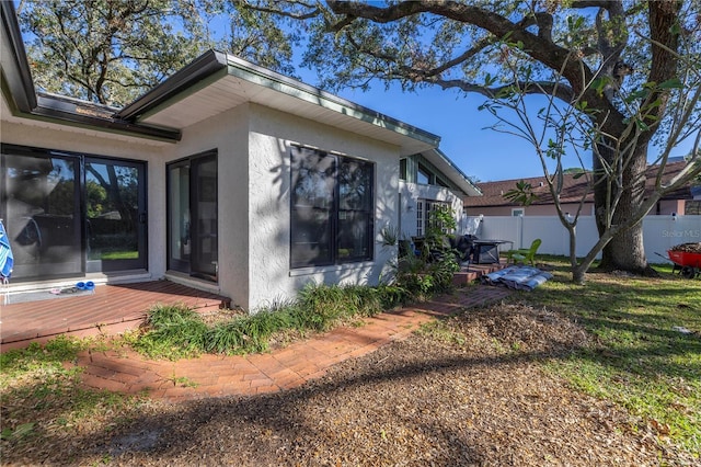 view of home's exterior with a wooden deck