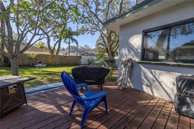 wooden terrace with a lawn