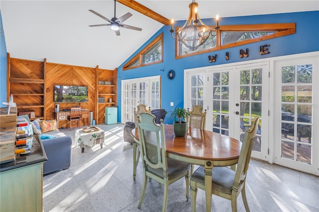 dining area featuring high vaulted ceiling, french doors, ceiling fan with notable chandelier, wooden walls, and beamed ceiling