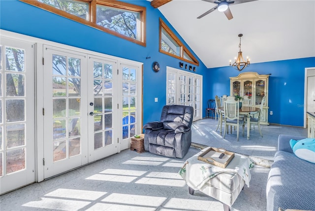 living room featuring french doors, ceiling fan with notable chandelier, plenty of natural light, and high vaulted ceiling