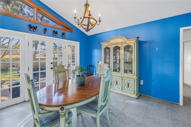 dining room featuring a chandelier, french doors, and lofted ceiling