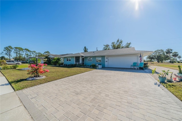 single story home featuring a front yard and a garage