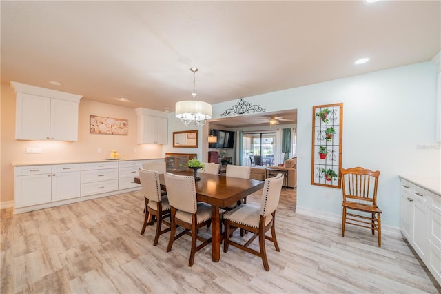 dining room featuring light wood-type flooring and a notable chandelier