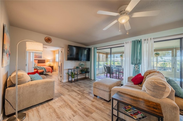 living room with light hardwood / wood-style flooring and ceiling fan