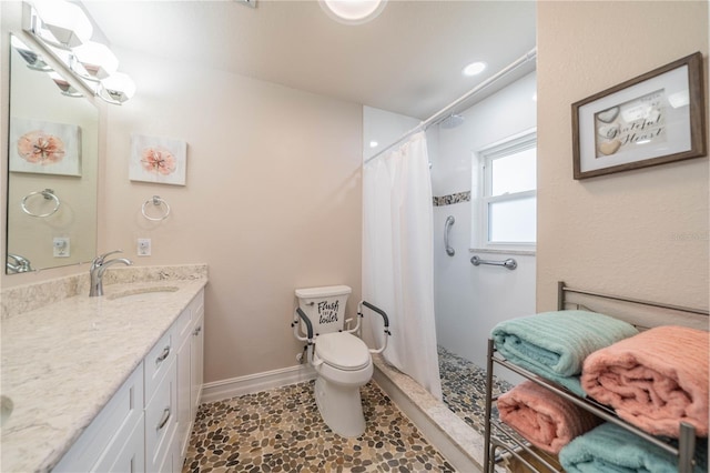 bathroom with vanity, toilet, and walk in shower