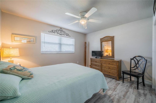 bedroom featuring light hardwood / wood-style flooring and ceiling fan