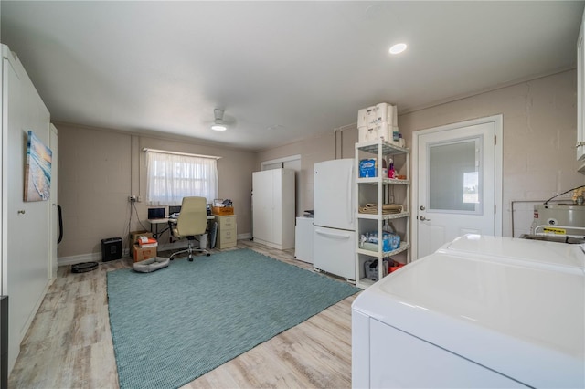 washroom with independent washer and dryer and light hardwood / wood-style flooring