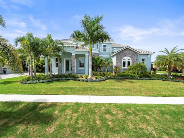 mediterranean / spanish-style home featuring a front lawn