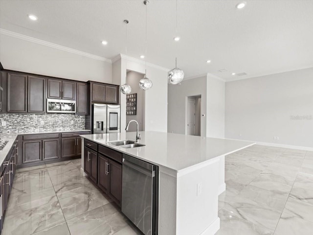 kitchen featuring decorative backsplash, stainless steel appliances, sink, decorative light fixtures, and a center island with sink