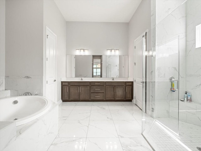 bathroom featuring vanity and independent shower and bath