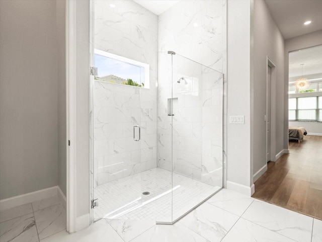 bathroom with hardwood / wood-style floors and an enclosed shower