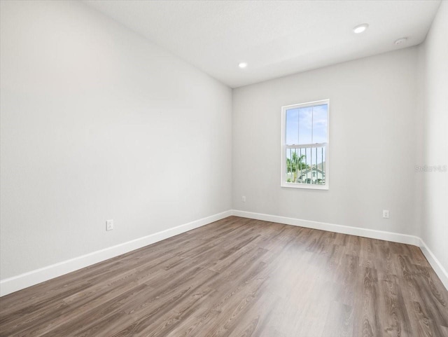 unfurnished room featuring hardwood / wood-style flooring