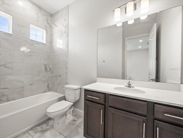 full bathroom featuring vanity, toilet, and tiled shower / bath