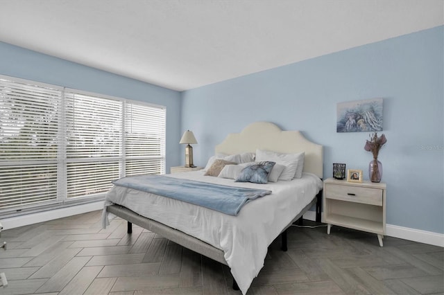 bedroom featuring dark parquet flooring