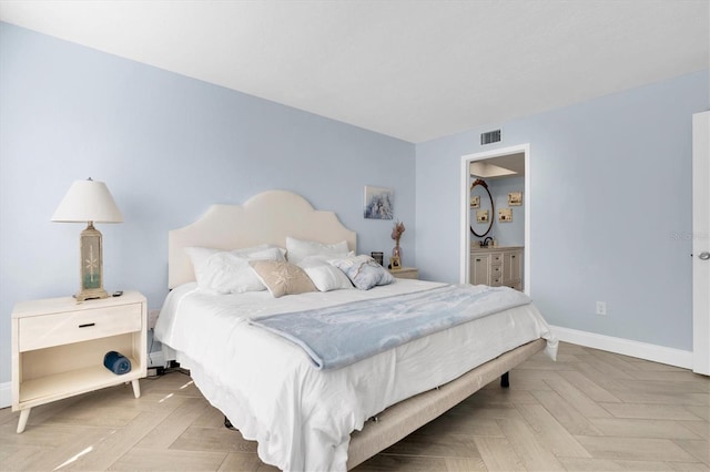 bedroom with ensuite bath and parquet floors