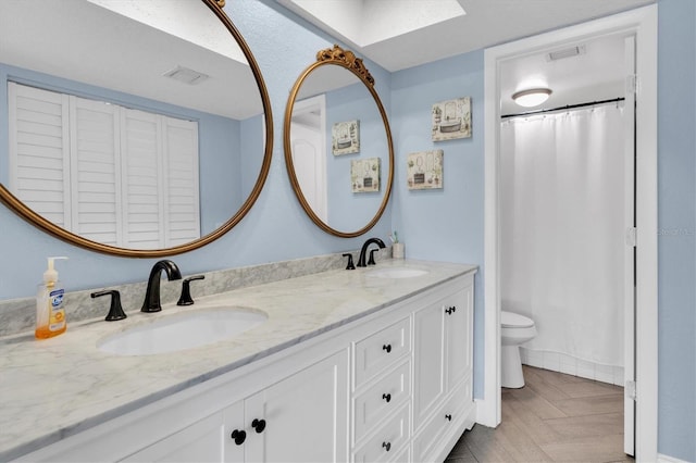 bathroom featuring vanity and toilet