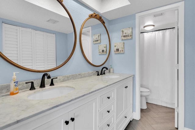 9000 Commodore Dr Unit 401, Seminole, FL 33776 - bathroom with a skylight, toilet, double vanity, and curtained shower