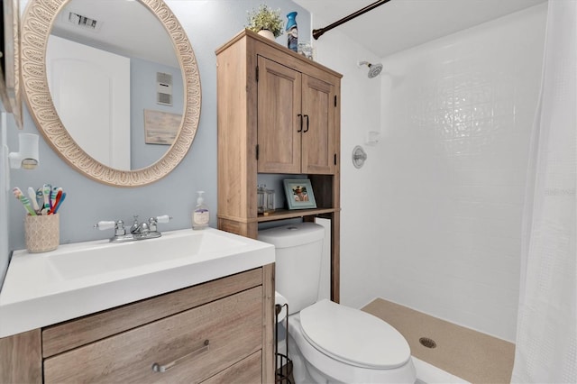 bathroom featuring a shower with shower curtain, vanity, and toilet