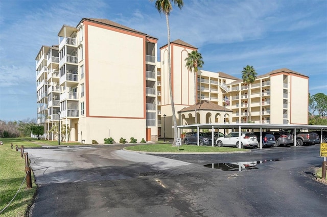 9000 Commodore Dr Unit 401, Seminole, FL 33776 - view of apartment building / complex featuring covered parking
