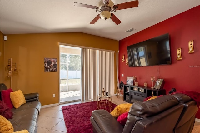 tiled living room with ceiling fan and vaulted ceiling